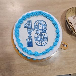 A close-up shot of the 18th-anniversary cake featuring graphics related to aviation and the timeline 2006–2024.